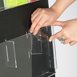 Insert folded brochures as well as magazines with adjustable-pocket literature holders Closeup of a divider getting inserted into an adjustable pocket literature holder