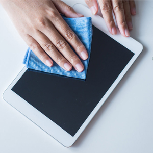 Person Cleaning Tablet with Microfiber Cloth