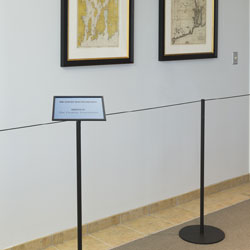 Museum stanchion accessories turn crowd control systems into customized informational displays Museum stanchion accessories
