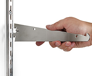 Slotted wall standard shelving systems are the affordable way to create heavy-duty storage space Closeup of a shelf bracket attaching to a wall standard