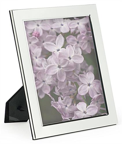 This silver plated picture frame has a glass lens silver plated picture frame