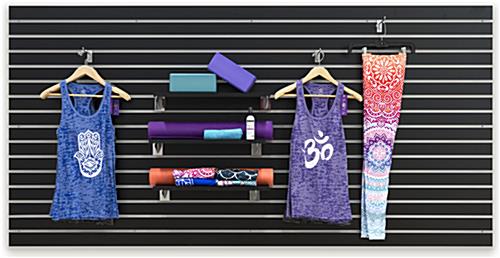Large Black Slat Board Display Panel with Horizontal Slots Yoga Clothes and Accessories on Large Black Slat Board Display Panel