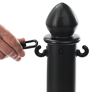 Closeup of a black plastic chain being attached to a stanchion post