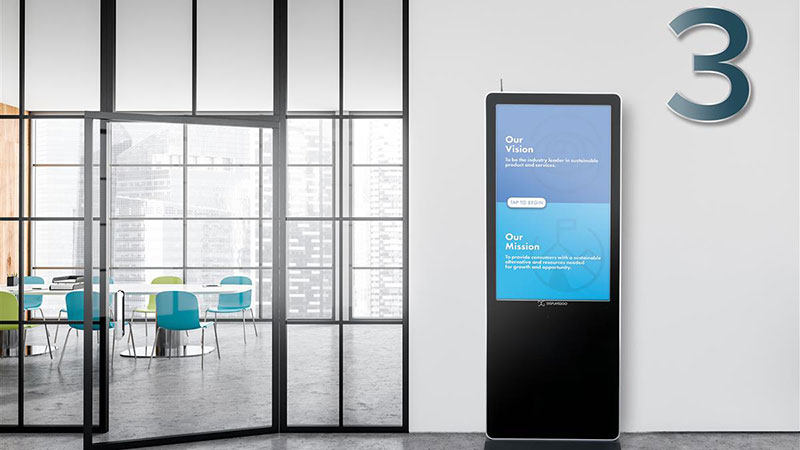 Touchscreen digital floor sign in an office environment