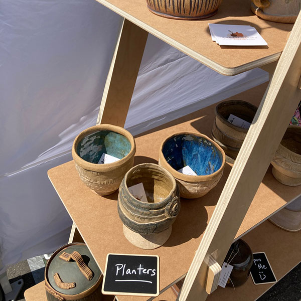 Wooden A-frame shelf displayed with craft fair products