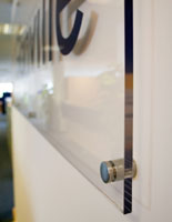 This type of sign hardware provides an alternative to simply fastening signs to walls with standard screws