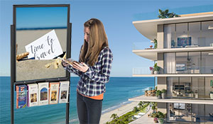 Woman checking out a brochure from a poster stand
