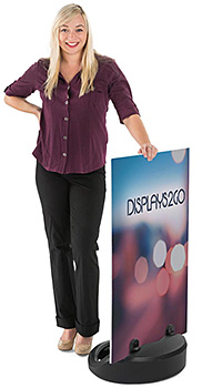 Woman standing next to a floor sign base with rigid signboard