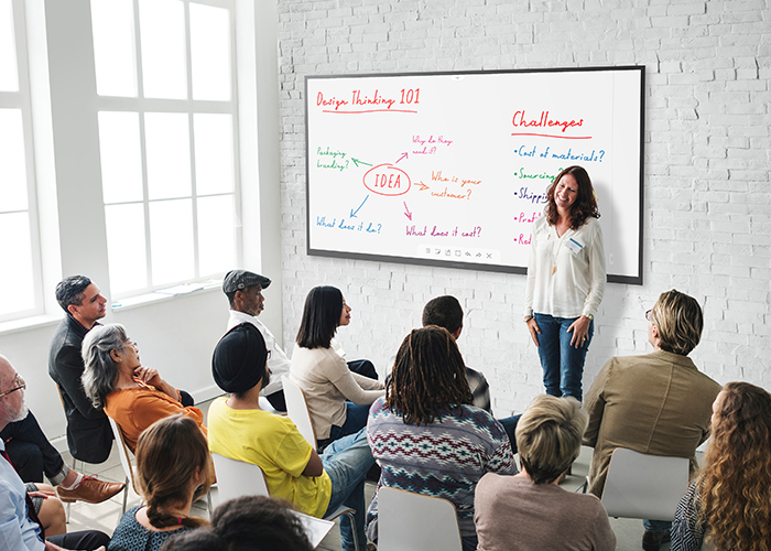interactive whiteboard being used in a classroom setting for a presentation