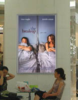 lighted movie poster frames promote new releases.