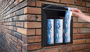 A literature holder mounted to an exterior brick wall