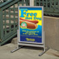 These sanwich boards capture customers' attention on a main city avenue.