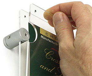 Closeup of a wall poster holder mounted with sign standoffs
