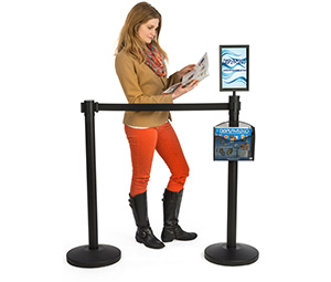 Woman filling out a form on a ledge-top stanchion accessory