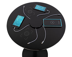 Phone wirelessly charging on a table pad