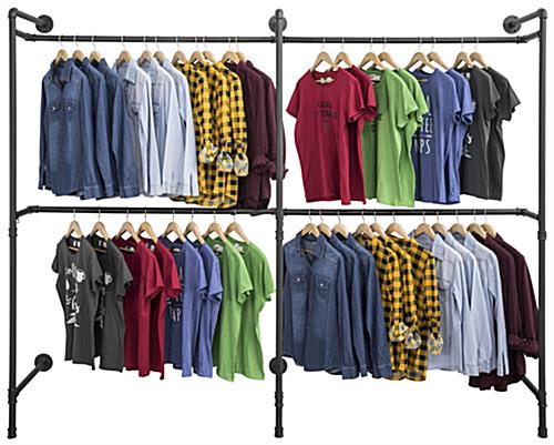 Industrial Wall Display Pipe Rack Showcasing Hanging Shirts