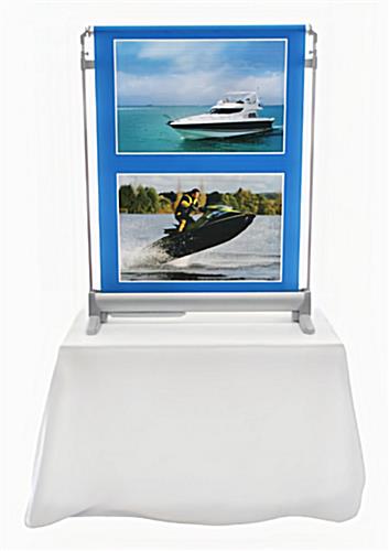 Front view of the scrolling tabletop banner on a table with a white throw
