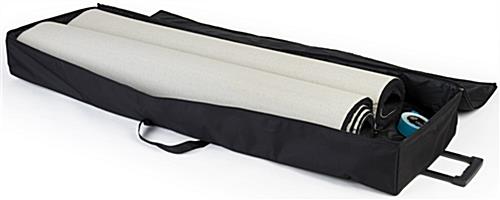 Black rolled trade show booth carpet shown with travel bag
