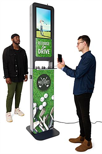 Two men standing beside Dual Screen 10-Device Charging Station with Custom Graphics