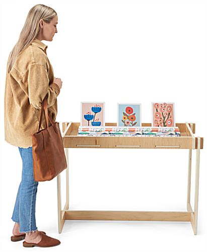Wooden retail dump table stands 30 inches tall and has a width of 44 inches