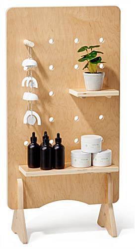 Wooden pegboard with shelves and natural wood finish 