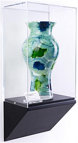 Wedge pedestal wall display case shown with vase