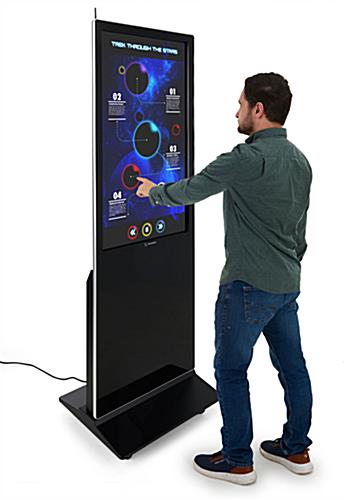 Man interacting with 43" touch screen digital poster