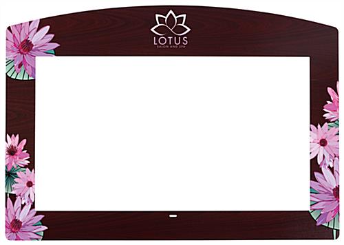 Stick-on faceplate for commercial monitors with custom printing and faux mahogany finish