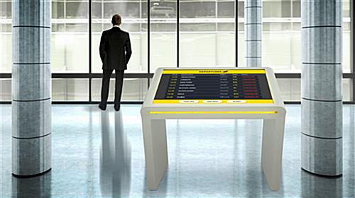 Edge-lit LCD touch screen kiosk in building lobby with LED lights set to yellow
