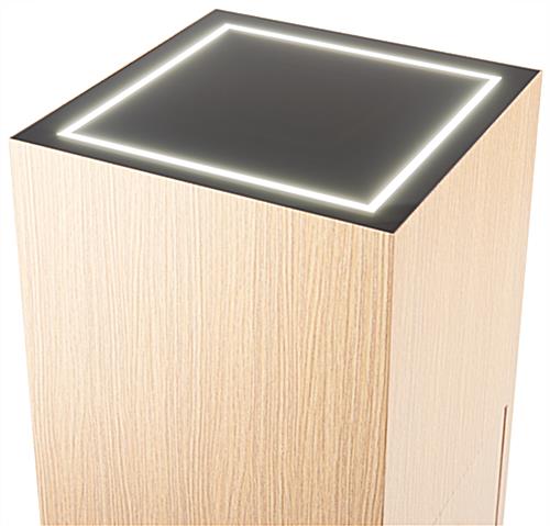 Top of oak pedestal display features LED lights built into the mirrored surface