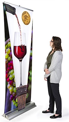Layered 3D retractable banner stand includes pre-installed graphic panels