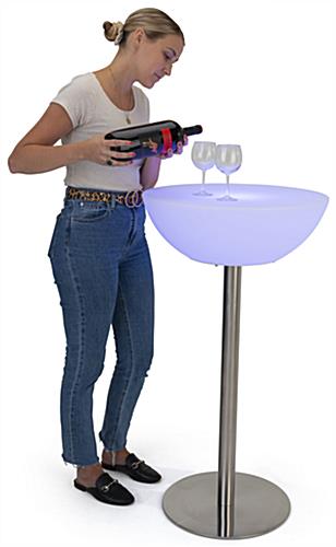 Woman serving wine on a half-moon LED cocktail table