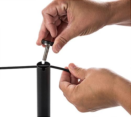 Hand Attaching Rope to Black Exhibit Stanchion