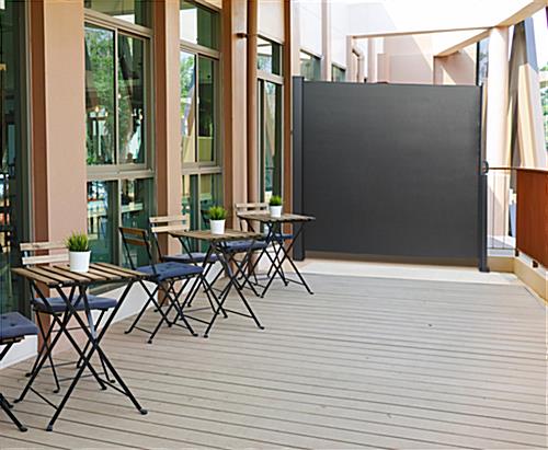Retractable outdoor privacy divider is ideal at restaurants 