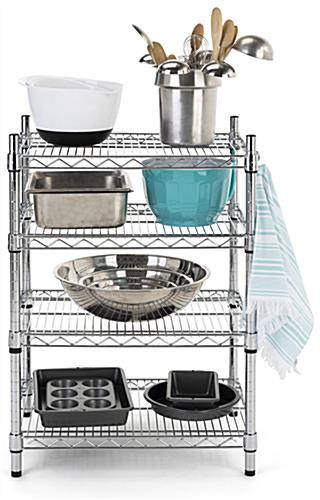 Metal wire shelving unit has four sturdy chrome tiers