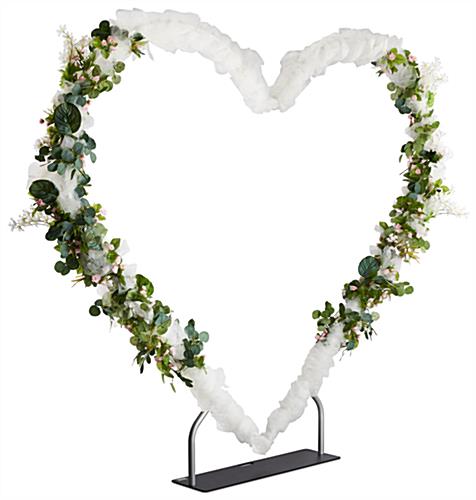 Heart shaped arch frame with flowers and ribbon 