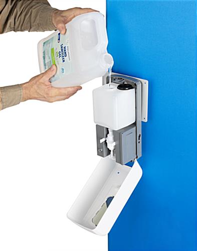 Touch free hand sanitizer with fold down door for easy refill