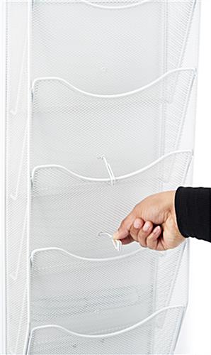 This mesh wall magazine rack with a pocket divider 