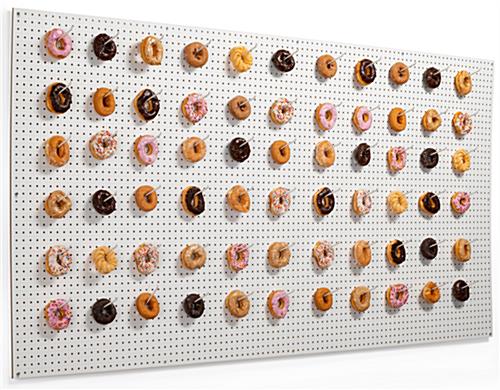 Wall-mounted large white pegboard