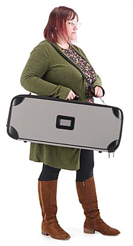 Woman carrying the 24"W Paramount banner in the included hard case