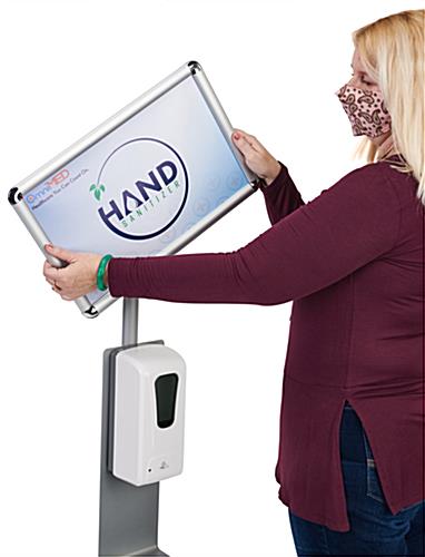 Sanitizing stand with rotating snap frame