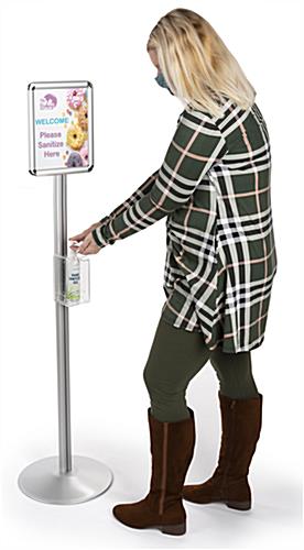 Standing sanitizer dispenser poster frame has adjustable height holder