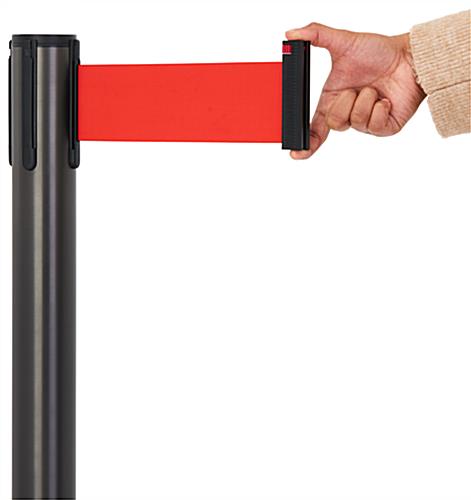 These retractable belt stanchions have a red nylon belt