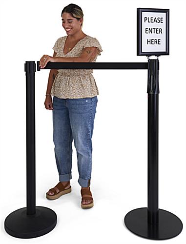 Stanchion with LED sign holder has a retractable belt 