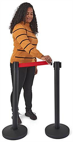 Red retractable belt barrier with an expandable band adaptor