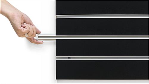 Person Removing Channel Insert of the Large Black Slat Board Display Panel