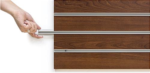 Hand Pulling out Slot Insert of  the Cherry Finish Large Slotted Wall Board Panel