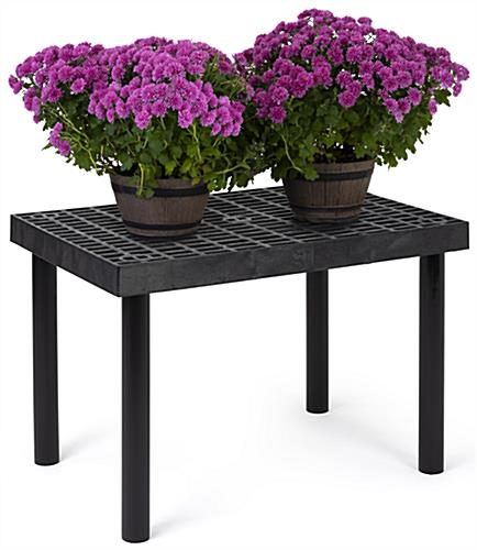Durable outdoor display table is made of recyclable plastic material