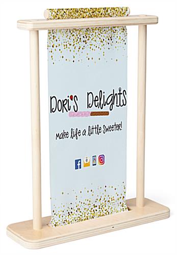 Small tabletop banner stand with wood frame and custom graphic insert