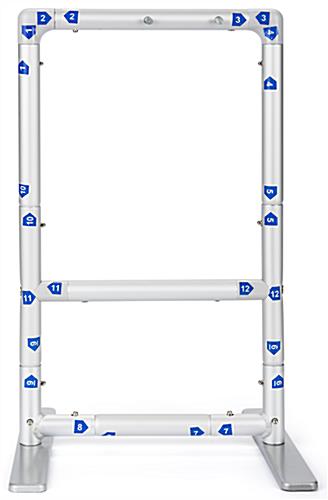 Tabletop sanitizer dispenser with banner and numbered push-pin assembly frame